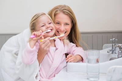 dental fillings lake oswego | mother and daughter brushing teeth