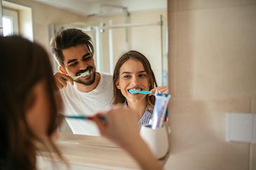 cosmetic dentist lake oswego | couple brushing teeth