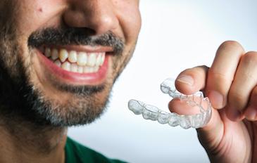 invisalign lake oswego | man with aligners
