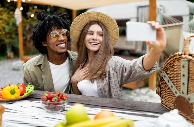 couple taking selfie at restaurant near Aesthetic Dentistry of Lake Oswego