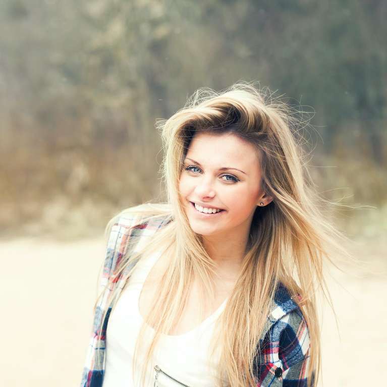 woman smiling after visiting holistic dentist lake oswego